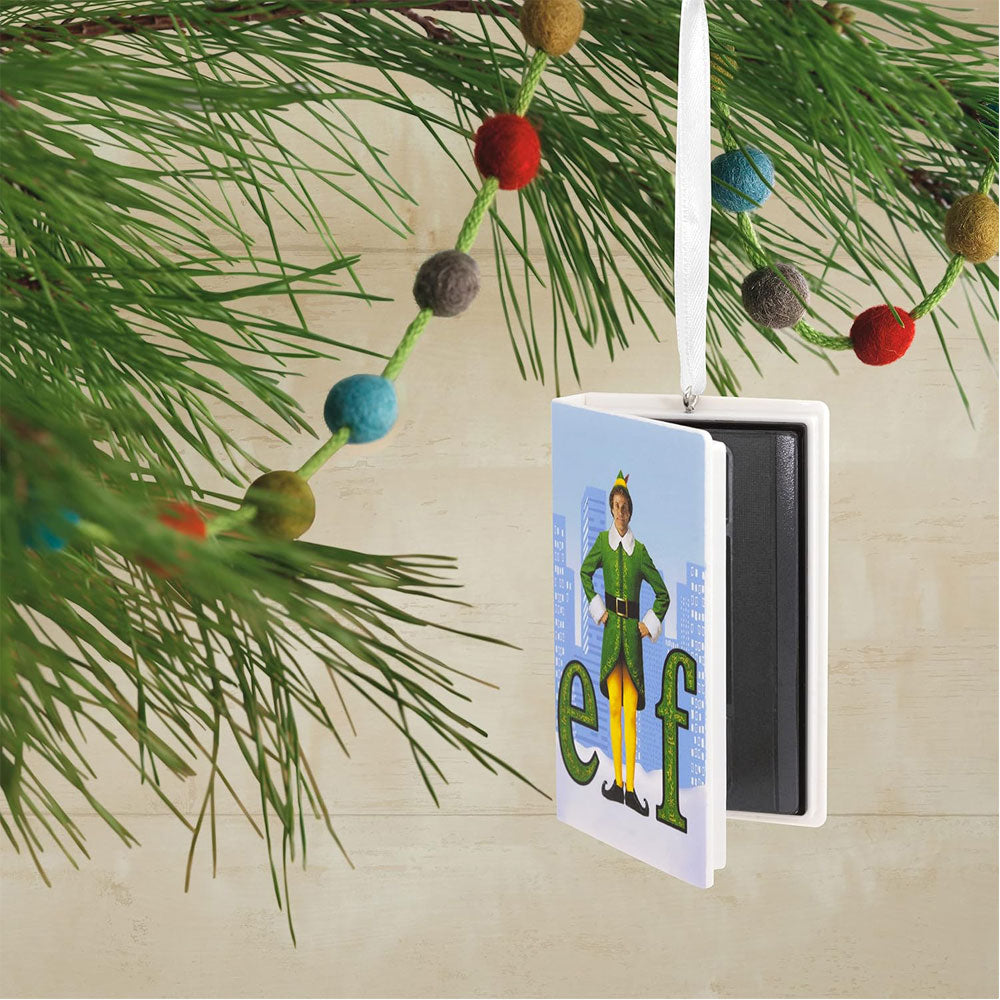Decorative ornament with 'elf' character on a Christmas tree branch