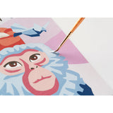 Close-up of a painting with a monkey's face and a brush applying paint.