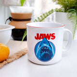 Mug with 'JAWS' design featuring a shark on a table with kitchen items in the background