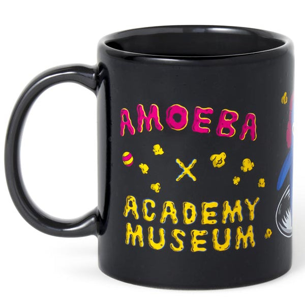 Black mug with colorful text and graphics on a white background Amoeba Records Los Angeles logo with the Academy Museum Store logo