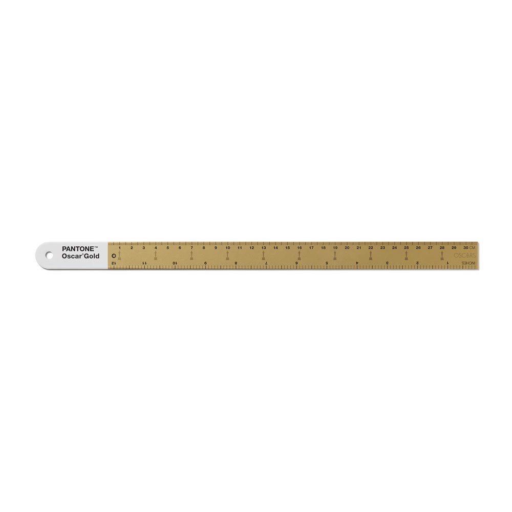 Gold metal ruler with Pantone Oscar Gold label on a white background