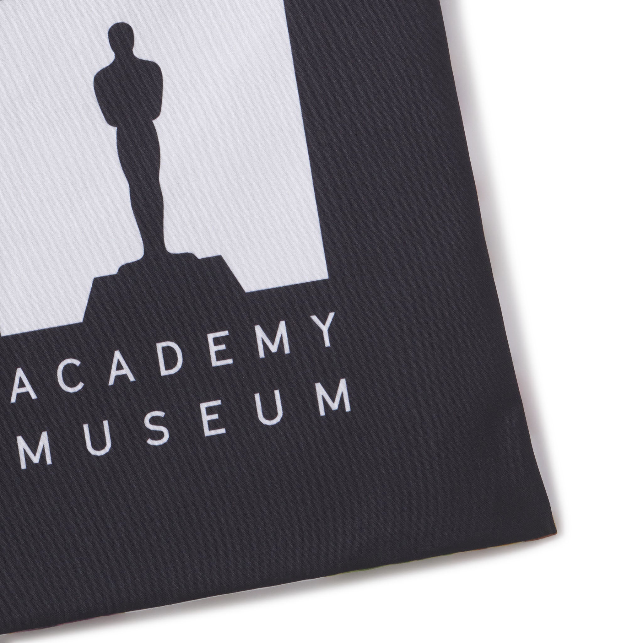 Academy Museum logo with silhouette of the Oscar statuette on a black background