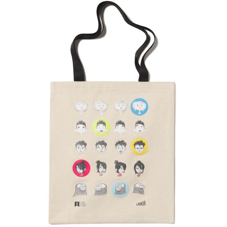 Beige tote bag with illustrated faces and icons the characted from Laika Animation Studio on a white background