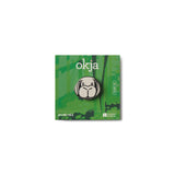 This is an enamel lapel pin on Green card with a logo and 'okja' text on a white background featuring the face of Okja from Bong Joon Ho's film Okja.