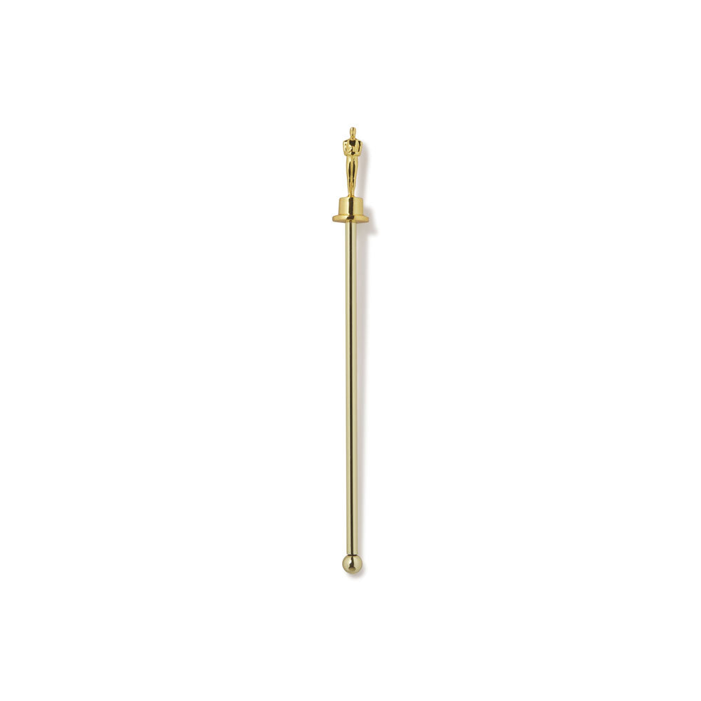 Gold-colored metal Oscar statue drink stirrer with a spherical end on a white background