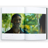 Open book showing a page with a man in a forest setting