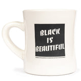 White mug with 'Black is Beautiful' text on a white background