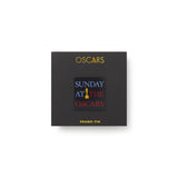Black box with 'OSCARs' and 'Sunday at the Oscars' text on a white background Oscars logo lapel pin.