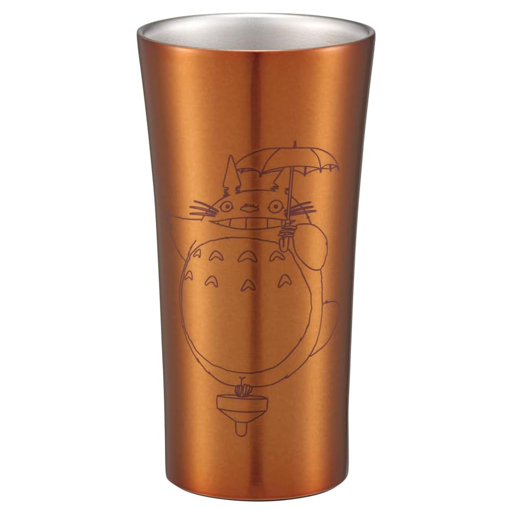 Bronze-colored tumbler with a character design on a white background