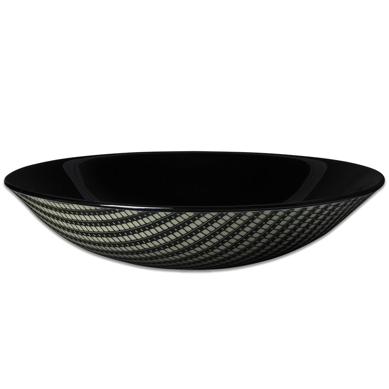 A black glass bowl with a geometric pattern in ivory-black-charcol color. Explore Kiku Handmade's stunning black glass bowl, adorned with a film graphic. Each piece is meticulously crafted by Laurie Freivogel in Chicago, merging art and design.