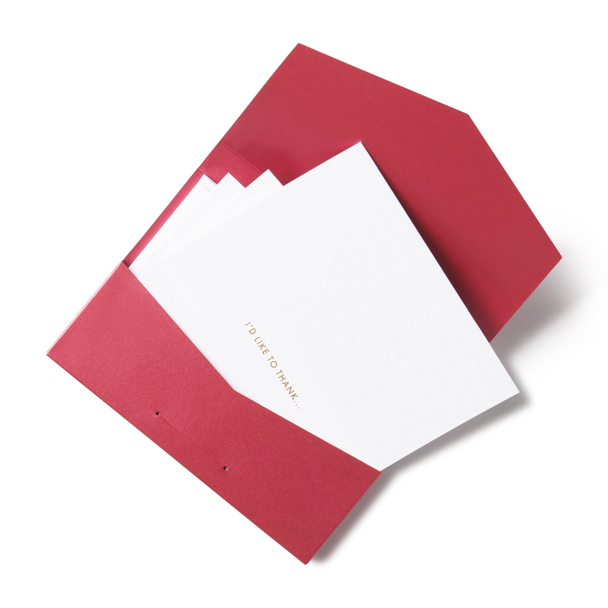 A set of red envelopes and white folded notecards with the Oscars gold logo monogram on the front.