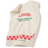 A white cotton tea towel with red and green text and graphics, including the text 'Louis Italian-American Restaurant' and a red checkered pattern. teatowel designed for the 50th anniversary of The Godfather movie