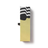Rectangular box with black and white wavy pattern on top and yellow bottom on a white background. Oscar Statue the Academy Awards Show official Oscars Logo Merchandise Collectible ballpoint pen in Oscars logo gift box.