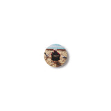 Round badge with a design of a person and text on a white background