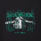 T-shirt with 'The Matrix' design featuring a person in a suit and digital code on a black background. Featuring the logo of Bran Dead and The Academy Museum of the movie The Matrix