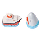 Toy boat and Jaws shark figure salt and pepper shaker set showing the holes on top on a white background