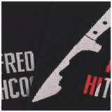 Black sock with white knife design and red text on a black background