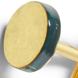 Close-up of a wooden mallet with a green and gold design on a white background