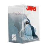 Packaged toy shark with 'Jaws' branding and 50th anniversary text on a white background