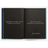 Open book with a quote by Joan Didion on black pages.