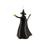 Black witch figurine with green hands on a white background