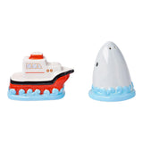 Toy boat and shark figure on a white background