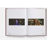 Open book showing two photographs of people on a white background
