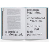Open book with text about romantic beginnings and crushes on a white background