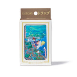 Packaged card game with illustration of a girl and shark in water, Studio Ghibli branding.