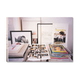 Collection of photo albums and prints on a white background