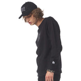 Person wearing a black sweatshirt and cap on a white background