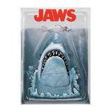 Packaged toy shark with 'JAWS' branding on a white background