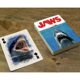 Playing cards with 'Jaws' design on a wooden surface
