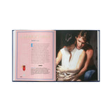 Book open to a page with a man holding a woman, text on the left side.