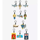 Collection of Jaws-themed keychains and tags on a white background