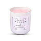 Candle in a white container with 'Academy Museum x Flores Lane' label on a white background FLORES LANE MOVIE GENRE SCENTED CANDLE: PERIOD MOVIE | ACADEMY MUSEUM