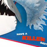 Shark with a saw blade and text 'Have a Killer Day!' on a blue background  JAWS 50th Anniversary Greeting Card 