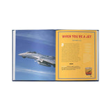 Open book with a photograph of an airplane on one page and text on the other, set against a white background.