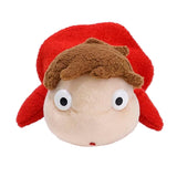 Small plush toy with a red hat and white face on a white background