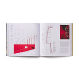 Open book showing architectural design with red stairs on a white background