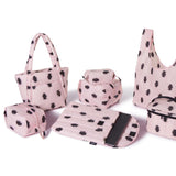 Set of pink bags with black roach print patterns on a white background