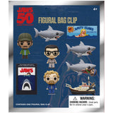 Jaws-themed figurine bag clip set with packaging featuring shark and character figures.