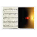 Sheet music on the left with a black hole image on the right