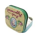 Tin with 'Pride and Prejudice' text and Jane Austen's name, featuring decorative elements on a white background.