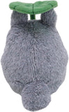 Plush toy resembling a gray creature with a green leaf on its back against a white background
