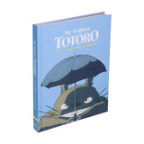 Book titled 'My Neighbor Totoro' with an illustration of Totoro holding an umbrella on a blue background.