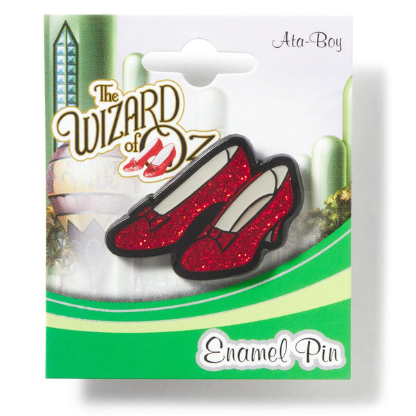 Enamel pin packaging featuring red shoes from 'The Wizard of Oz' on a white background