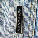 Metallic badge with symbols on a denim background