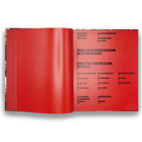 Open book with red cover displaying text on a white background