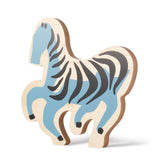 Wooden zebra toy figure with blue and black stripes on a white background